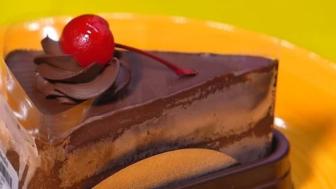 Chocolate cake square Spin on orange palette Stock Footage 74202262