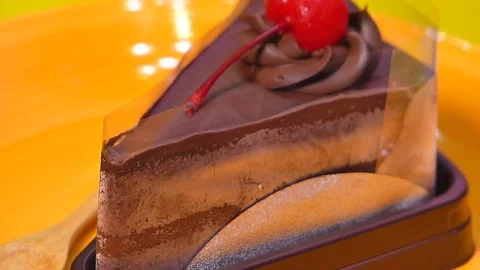 Chocolate cake square Spin on orange palette Stock Footage 74202305