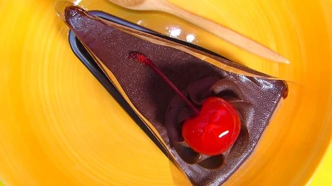 Chocolate cake square Spin on orange palette Stock Footage 74202398