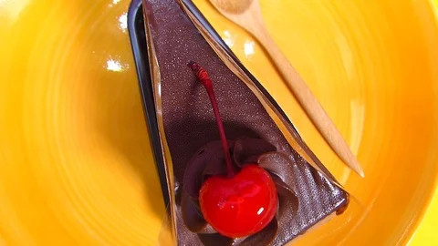 Chocolate cake square Spin on orange palette Stock Footage 74202440