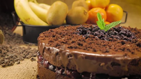 Chocolate cake on a straw-covered table. The chef puts the final touch. Close up Stock Footage 144310059