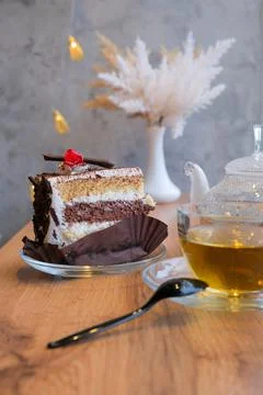 Chocolate cake with tea set in cafe, elegant serving of dessert in cafe, sele Stock Photos