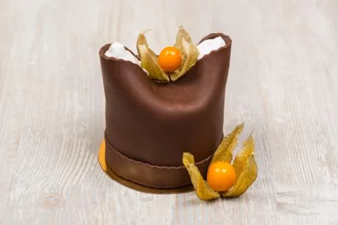 The chocolate cake with two berries on the table Stock Photos