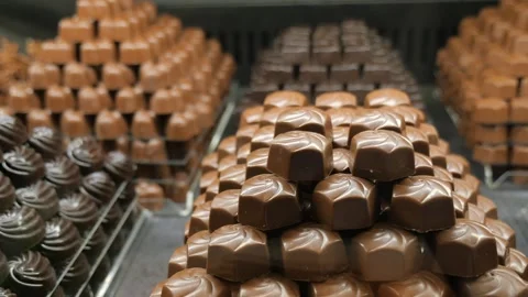 Chocolate candies arranged in creative patterns in a shop Stock Footage 320333545