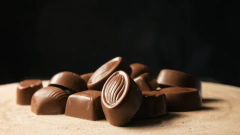 Chocolate candies on a black background. Close up. Movement of light Stock Footage 263065490