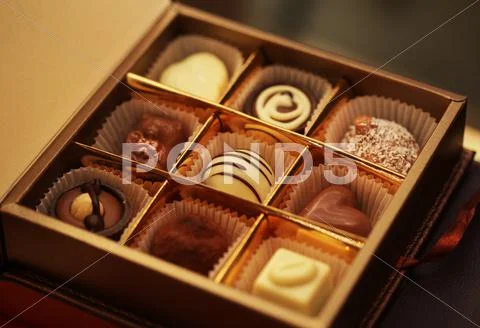 Chocolate candies in a box Stock Photos