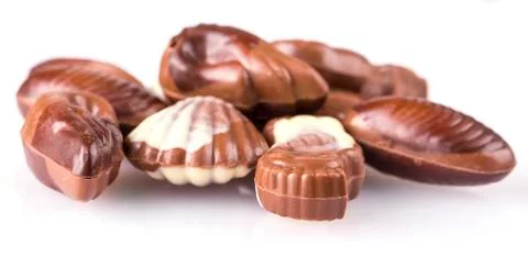 Chocolate candies in the form of seafood on white background Stock Photos