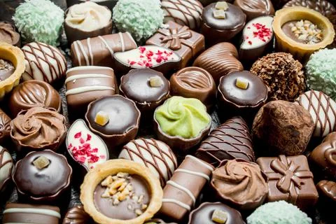 Chocolate candies with nuts and various fillings. Stock Photos