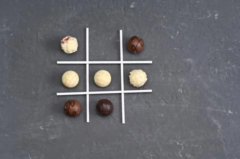 Chocolate candies positioned as tic tac toe game Foto stock