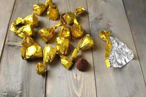 Chocolate candy and wrapper for packaging. Packaging of homemade sweets proce Stock Photos