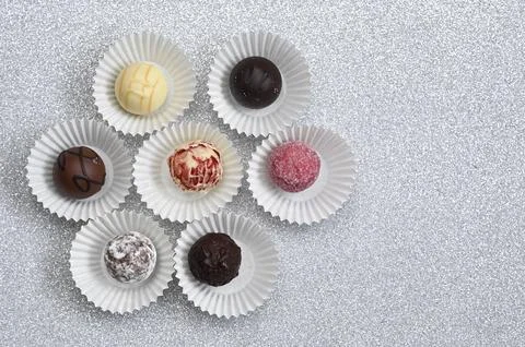 Chocolate candy assortment arranged in circular composition on light background, Stock Photos