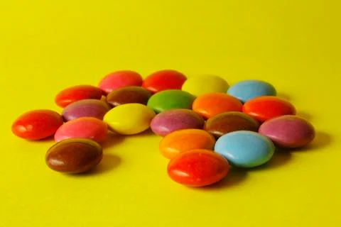 Chocolate Candy Beans on a Yellow Background Stock Photos
