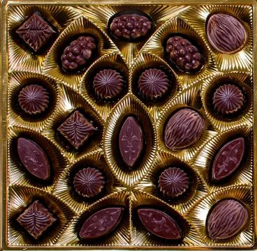 Chocolate candy in a box on a dark background Stockfoto's