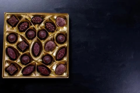 Chocolate candy in a box on a dark background Stock Photos