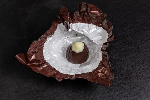 Chocolate candy conical shape with white top in unwrapped wrapper Stock-Fotos