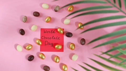 Chocolate candy eggs with a note World Chocolate Day. Stock Footage 307970810