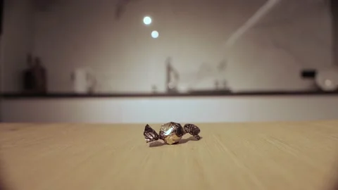 Chocolate candy in a golden wrapper lies on the table at home, close-up Stock Footage 165441670