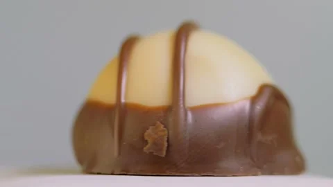 Chocolate candy isolated on white background, macro, rotation. Sweet dessert Stock Footage 147223238