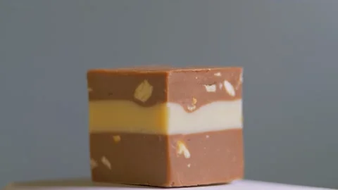 Chocolate candy isolated on white background, macro, rotation. Sweet dessert Stock Footage 147293077