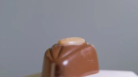 Chocolate candy isolated on white background, macro, rotation. Sweet dessert Stock-Footage 147293566