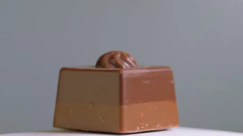 Chocolate candy isolated on white background, macro, rotation. Sweet dessert Stock Footage 147358310