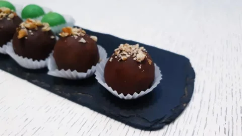 Chocolate candy with nuts, green chocolate, author candy,sale, restaurant Stock Footage 313725924