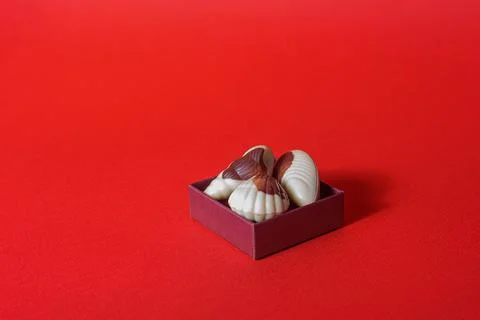 Chocolate candy shells on red background Foto stock