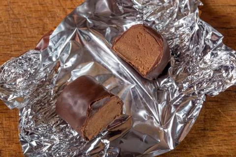 Chocolate candy on silver foil 스톡 사진