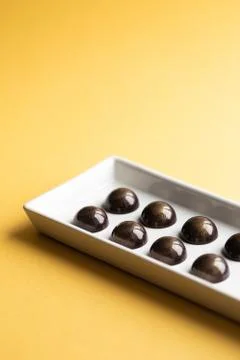 Chocolate candy on an yellow background Stock Photos