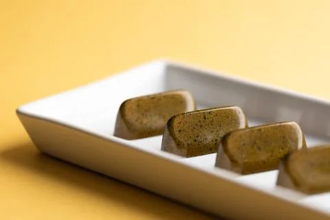 Chocolate candy on an yellow background Stock Photos