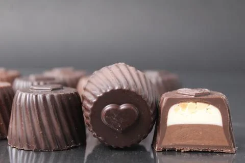 Chocolate case candy in section with filling chocolate vanilla mousse ganac.. Stock Photos
