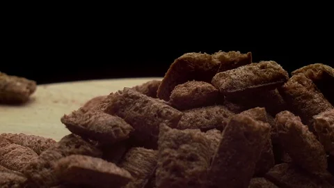 Chocolate cereal flakes rotates on a wooden board Stock Footage 117315744