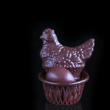 Chocolate chicken and eggs in Easter basket 写真素材