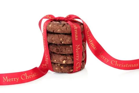 Chocolate chip cookie biscuit stack with merry christmas red ribbon over wh.. Stock Photos