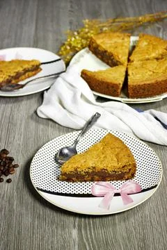Chocolate chip cookie cake on gray background with coffee beans and gypsophila f Stock Photos