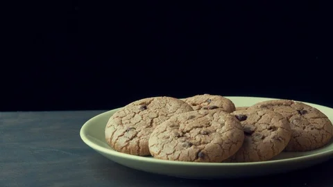 Chocolate chip cookie spins on a plate Stock Footage 120086977