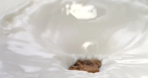 Chocolate chip cookie splashing into milk in super slow motion 1000 fps Stock Footage 344849534