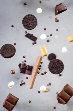 Chocolate chip cookies and candy falling Stockfoto's