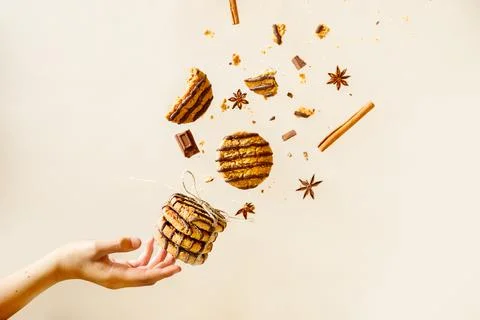 Chocolate chip cookies and spices, gloves and cinnamon, flying over plain Stock Photos