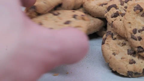 Chocolate Chip Cookies Being Grabbed by hand from White Plate, Close‑Up Stock Footage 248454613