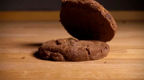 Chocolate chip cookies drop onto table, slow motion Stock Footage 61691264