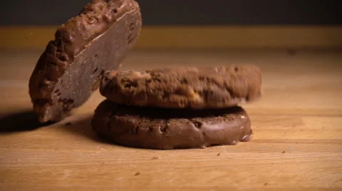 Chocolate chip cookies fall onto table, slow motion Stock Footage 61691212