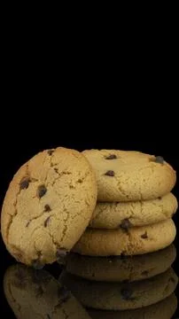 Chocolate Chip Cookies Stack on Black Background with Reflection Fotos de archivo