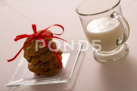 Chocolate Chip Cookies Stacked with Red Bow and a Glass of Milk Stock Photos
