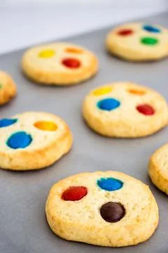 Chocolate chips and multicolored candy homemade shortbread cookies on gray Stock Photos