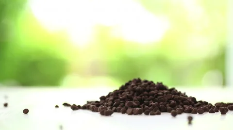 Chocolate chips pouring on the table Stock Footage 51928809