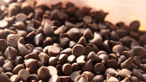 Chocolate chips spilling from a plastic packet, Stock Footage 167831882