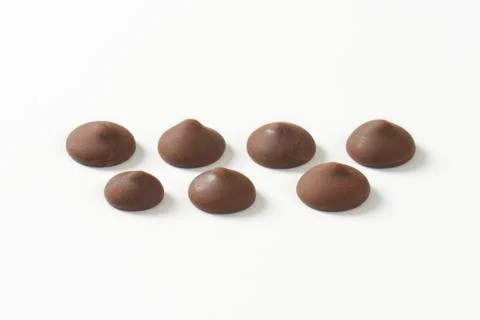 Chocolate chips on white background Stock Photos