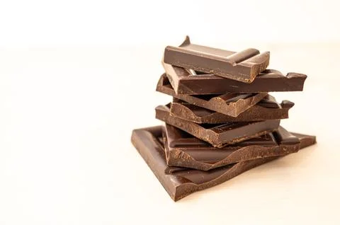 Chocolate chips on white surface Stock Photos
