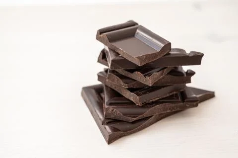 Chocolate chips on white surface Stock Photos